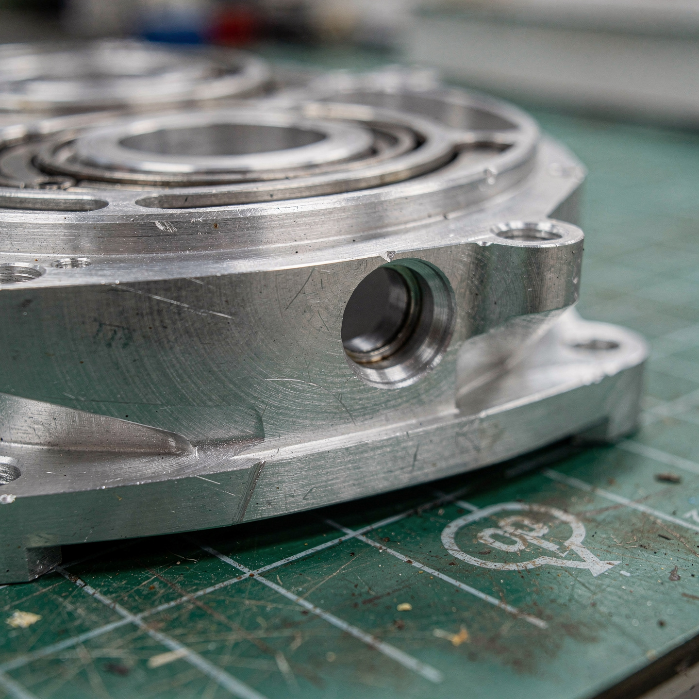 Machined aluminum gearbox housing for a robotic joint with visible bearing bores